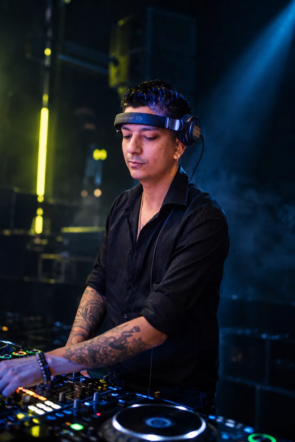 Portrait of Scott Jordan in headphones and a black shirt, playing a set